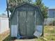 Exterior of a weathered shed on an overgrown lot with peeling paint and a damaged exterior at 3538 Pinetree St, Port Charlotte, FL 33952