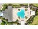 Aerial view of pool surrounded by lounge chairs, umbrellas, lush landscaping and sidewalks at 3664 Tin Cup Blvd, Sarasota, FL 34232
