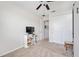 Cozy bedroom featuring neutral carpet, a ceiling fan, closet and a television on a bookshelf at 3664 Tin Cup Blvd, Sarasota, FL 34232