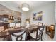 A charming dining area with a dark wood table, seating for six, and a view into the adjacent, updated kitchen at 3664 Tin Cup Blvd, Sarasota, FL 34232