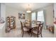 Inviting dining room with a rustic table, chandelier lighting, decorative wall art, and large window with sheer curtains at 3664 Tin Cup Blvd, Sarasota, FL 34232