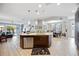 Open kitchen design featuring a center island, stainless steel dishwasher, and seamless flow into the living and dining areas at 3664 Tin Cup Blvd, Sarasota, FL 34232
