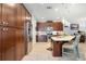 Spacious kitchen with dark wood cabinets, stainless steel appliances, and a center island at 3664 Tin Cup Blvd, Sarasota, FL 34232