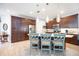 Well-lit kitchen with an island, pendant lights, stainless steel appliances, and ample cabinet space for storage at 3664 Tin Cup Blvd, Sarasota, FL 34232