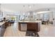 Open-concept kitchen with a central island, stainless steel appliances, and seamless flow to the living area at 3664 Tin Cup Blvd, Sarasota, FL 34232
