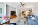 Spacious living room with wood-look tile flooring and an open layout to the kitchen and dining area at 3664 Tin Cup Blvd, Sarasota, FL 34232