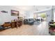 Comfortable living area featuring a blue sofa, desk space, large window, and tile flooring, creating a serene environment at 3664 Tin Cup Blvd, Sarasota, FL 34232
