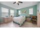 Bright and airy main bedroom featuring tile flooring, light blue walls, and a ceiling fan at 3664 Tin Cup Blvd, Sarasota, FL 34232