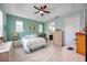 Spacious main bedroom with light blue walls, tray ceiling, tile flooring, and a view of the ensuite at 3664 Tin Cup Blvd, Sarasota, FL 34232