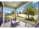 Covered patio with outdoor seating, overlooking a fenced yard and mature landscaping at 3664 Tin Cup Blvd, Sarasota, FL 34232