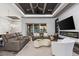 Open concept living room with fireplace, modern ceiling fan, access to backyard, and comfy furniture at 3729 Peace River Dr, Punta Gorda, FL 33983
