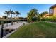 Lush green backyard with a canal, dock, and vibrant landscaping near the water's edge at 3729 Peace River Dr, Punta Gorda, FL 33983