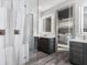 A bright bathroom with dual vanities, modern fixtures, large mirrors, and walk-in shower at 3729 Peace River Dr, Punta Gorda, FL 33983