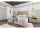 Cozy bedroom showcasing neutral tones, tray ceilings, and elegant pendant lighting at 3729 Peace River Dr, Punta Gorda, FL 33983
