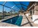 Wide view of screened-in pool with outdoor kitchen and patio furniture for relaxing at 3729 Peace River Dr, Punta Gorda, FL 33983