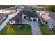 Beautiful aerial view of a modern home boasting a long paved driveway, lush landscaping, and canal access at 3729 Peace River Dr, Punta Gorda, FL 33983