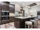 Gourmet kitchen with stainless steel appliances, large island, and modern light fixtures at 3729 Peace River Dr, Punta Gorda, FL 33983