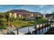 Backyard view featuring a covered patio, lush lawn, landscaping, and a private dock at 3729 Peace River Dr, Punta Gorda, FL 33983