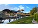 Picturesque waterfront view with a covered boat lift and lush green landscaping at 3729 Peace River Dr, Punta Gorda, FL 33983