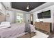 Comfortable bedroom featuring scenic views from large windows and sliding glass door at 3729 Peace River Dr, Punta Gorda, FL 33983