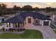 Stunning single-story home boasts a modern design, brick driveway, well-manicured lawn, and waterfront access at 3729 Peace River Dr, Punta Gorda, FL 33983