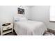Cozy bedroom with a white bedspread, side table, neutral paint, and minimal decor at 3729 Peace River Dr, Punta Gorda, FL 33983