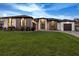 Charming home exterior featuring a manicured lawn, neutral color palette, and a welcoming entrance at 3729 Peace River Dr, Punta Gorda, FL 33983