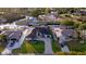 Aerial view of a modern single Gathering home with a paver driveway and lush landscaping at 3729 Peace River Dr, Punta Gorda, FL 33983