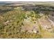 An aerial view of a large parcel with a house and surrounding greenery at 47350 Bermont Rd, Punta Gorda, FL 33982