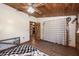 Cozy bedroom with wood ceiling, hardwood floors and a decorative curtain at 47350 Bermont Rd, Punta Gorda, FL 33982