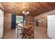 Dining area featuring a wooden table, chairs and blue curtains at 47350 Bermont Rd, Punta Gorda, FL 33982