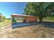 Open carport with a concrete slab and storage space at 47350 Bermont Rd, Punta Gorda, FL 33982