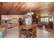 Open kitchen featuring stainless steel appliances, wooden cabinets, round table, and an inviting dining area at 47350 Bermont Rd, Punta Gorda, FL 33982