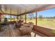 Relaxing screened porch featuring comfortable seating and a serene view of the lush surrounding landscape at 47350 Bermont Rd, Punta Gorda, FL 33982