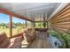 Spacious screened porch providing a great outdoor living space with rustic wood finishes and comfortable seating at 47350 Bermont Rd, Punta Gorda, FL 33982