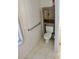 Compact bathroom featuring a toilet, grab bar, and a cabinet for storage at 5050 Prosch Cir, North Port, FL 34288