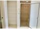 Bathroom with a walk-in shower, built-in seat, and a linen closet for storage at 5050 Prosch Cir, North Port, FL 34288
