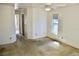 Bright bedroom featuring worn carpet flooring, a ceiling fan, a window, and doorways to other rooms at 5050 Prosch Cir, North Port, FL 34288