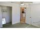 Bedroom featuring a walk-in closet, ceiling fan, and view into the kitchen at 5050 Prosch Cir, North Port, FL 34288