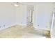 Spacious bedroom featuring worn carpet flooring, a ceiling fan, and an entryway to another room at 5050 Prosch Cir, North Port, FL 34288