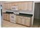 View of the kitchen featuring ample cabinet space and dated appliances at 5050 Prosch Cir, North Port, FL 34288