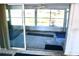 Enclosed porch with sliding glass doors leading to the outside and concrete flooring at 5050 Prosch Cir, North Port, FL 34288