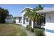 This single Gathering home is surrounded by mature landscaping that includes palms and shrubbery at 5050 Prosch Cir, North Port, FL 34288
