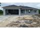 New construction home featuring a gray exterior, garage, and architectural windows at 7 Pine Valley Ct, Rotonda West, FL 33947