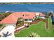 Gorgeous waterfront home with a lush green lawn, a private dock, and a sparkling pool, offering a serene coastal retreat at 8115 Manasota Key Rd, Englewood, FL 34223