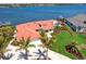 Expansive waterfront estate boasting meticulous landscaping, a private dock, and a sparkling pool, showcasing luxurious coastal living at 8115 Manasota Key Rd, Englewood, FL 34223