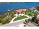Beautiful waterfront home with a private dock and lush landscaping, showcasing great curb appeal and water access at 8115 Manasota Key Rd, Englewood, FL 34223