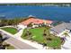 Beautiful waterfront home with lush landscaping, a private dock, and a screened-in pool, showcasing a luxurious coastal lifestyle at 8115 Manasota Key Rd, Englewood, FL 34223