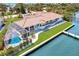 Aerial of waterfront home showcasing a pool, lush landscaping, and a private dock at 8115 Manasota Key Rd, Englewood, FL 34223