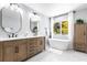 Stylish bathroom with a soaking tub, double sink vanity and lots of natural light at 8115 Manasota Key Rd, Englewood, FL 34223